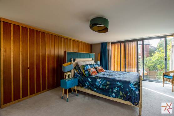 3256C-17-tv-commercial-location-house-in-Cheshire-stylish-master-bedroom-with-feature-wooden-wall.jpg