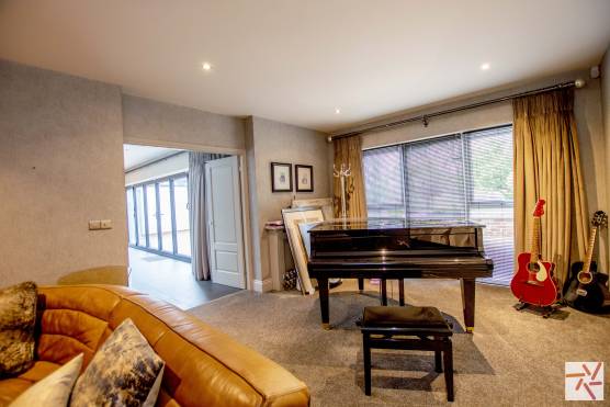 3280C 12 TV Drama location house in Cheshire cosy living space with grand piano and large windows.jpg