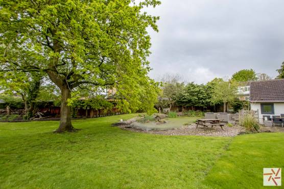 3280C 22 filming location house in Cheshire large open back garden with pond and patio area.jpg