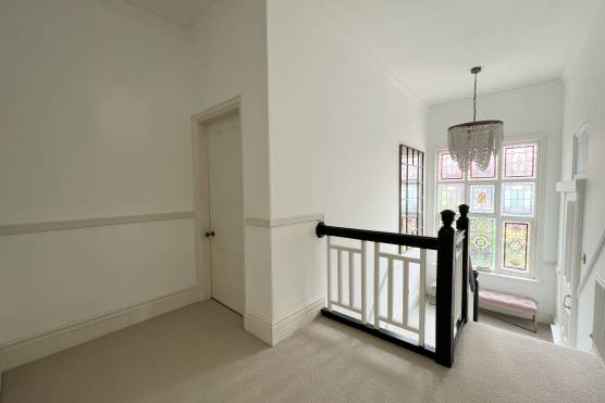 3422M 29 tv shoot location house in Manchester with large light staircase with stained window