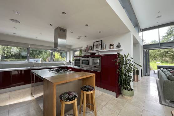 3427C 8 tv shoot location house in Cheshire modern open plan red kitchen