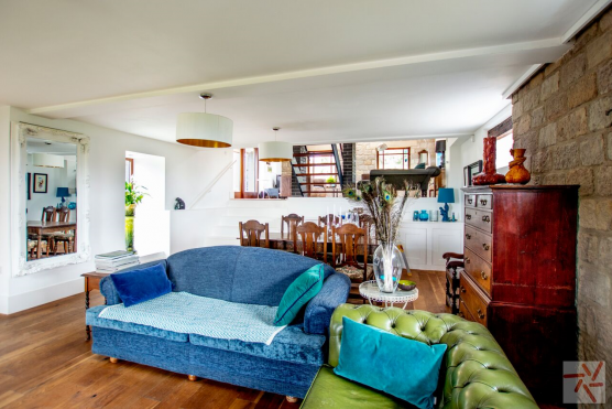 3148W traditional dining and living area with exposed brickwork and staircase for filming and photography hire in West Yorkshire